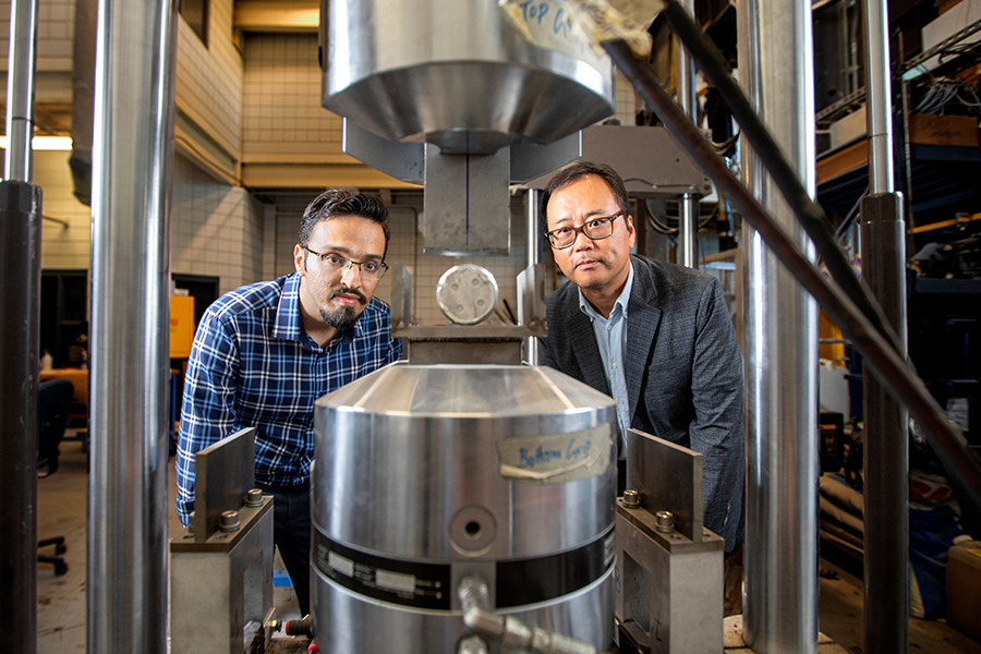 Doctoral candidate and lead author Farhad Farzaneh, left, and Sungmoon Jung, professor in the Department of Civil and Environmental Engineering, look over experiments they are conducting on electric vehicle battery safety at the FAMU-FSU College of Engineering. (Mark Wallheiser/FAMU-FSU College of Engineering)