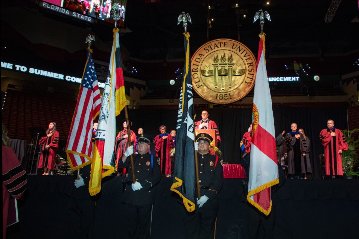 The Seminole Tribe of Florida Color Guard presents the colors at FSU's summer doctoral hooding ceremony Friday, Aug. 4, 2023.(FSU Photography)