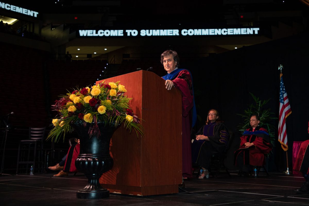 Florida State University Provost Jim Clark congratulates graduates during the summer doctoral hooding ceremony Friday, Aug. 4, 2023, at the Donald L. Tucker Civic Center. (FSU Photography)