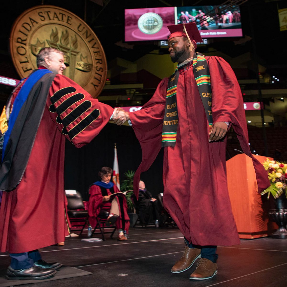 Florida State University President Richard McCullough congratulates a graduate during the summer commencement Friday, Aug. 4, 2023, at the Donald L. Tucker Civic Center. (FSU Photography Services)