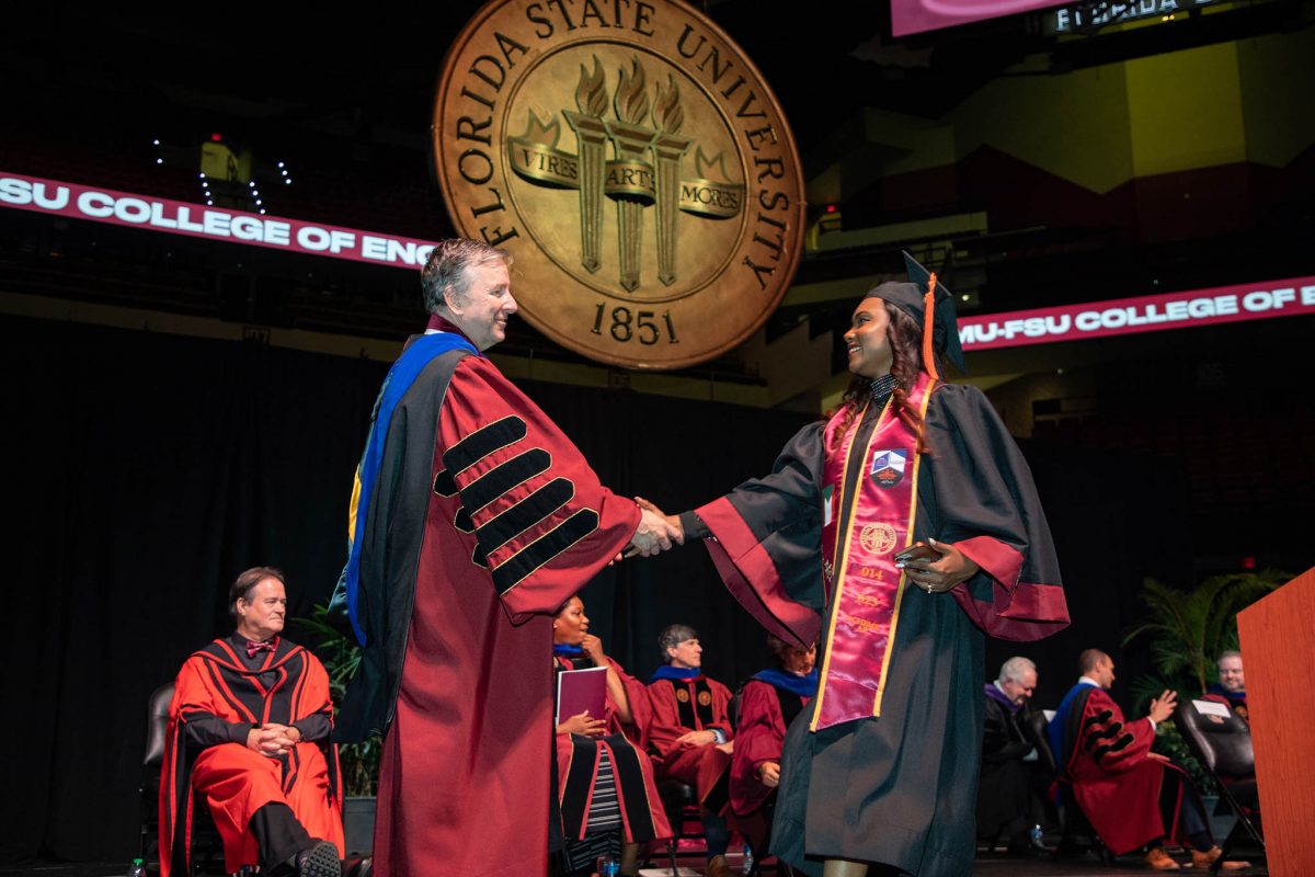 Florida State University President Richard McCullough congratulates a graduate during the summer commencement Friday, Aug. 4, 2023, at the Donald L. Tucker Civic Center. (FSU Photography Services)