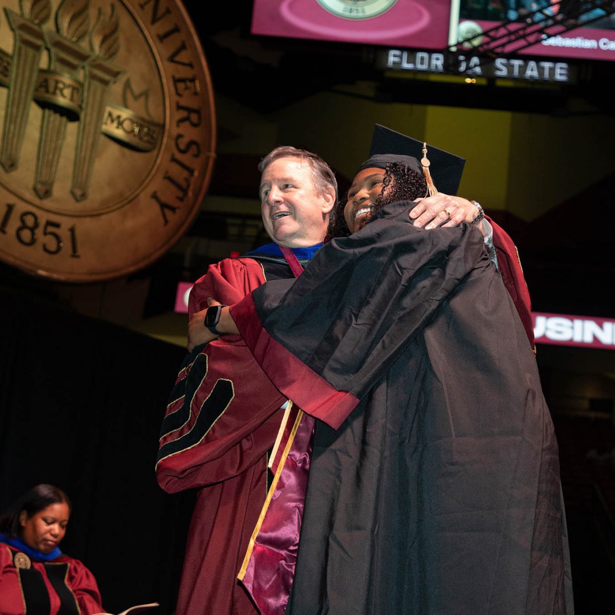 Florida State University President Richard McCullough celebrates with a graduate during summer commencement Friday, Aug. 4, 2023, at the Donald L. Tucker Civic Center. (FSU Photography Services)