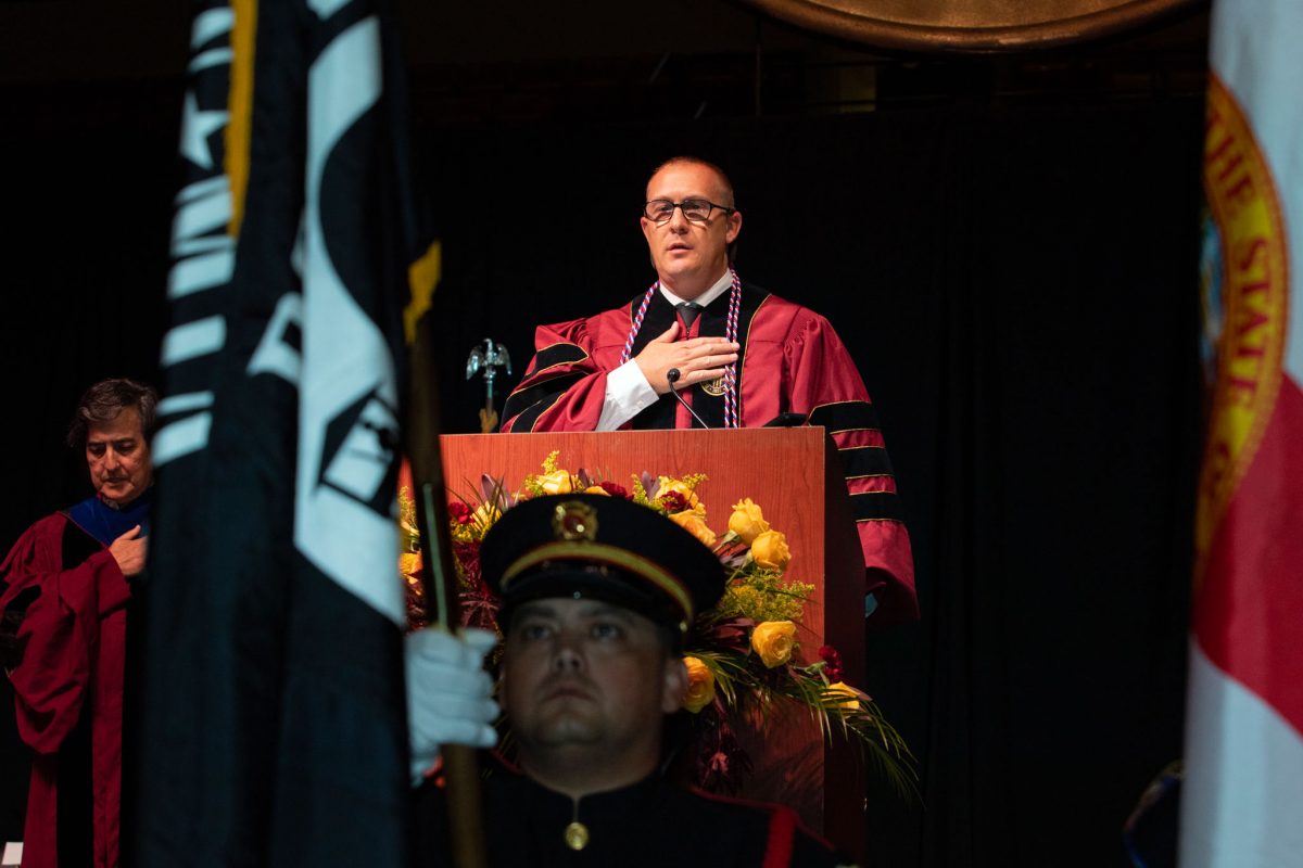 Daniel Timme leads the Pledge of Allegiance at FSU's summer doctoral hooding ceremony Friday, Aug. 4, 2023. Timme is graduating with a Doctor of Philosophy in Statistics. He commissioned into the United States Air Force in May 2013 and was promoted to the rank of Major in April 2023. (FSU Photography)