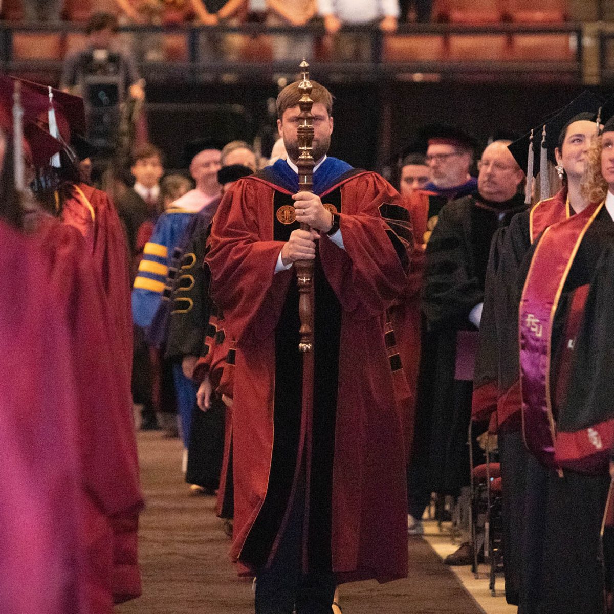 Florida State University Director of Institutional Research James Hunt carries the mace to lead the processional during summer commencement Friday, Aug. 4, 2023, at the Donald L. Tucker Civic Center. (FSU Photography Services)