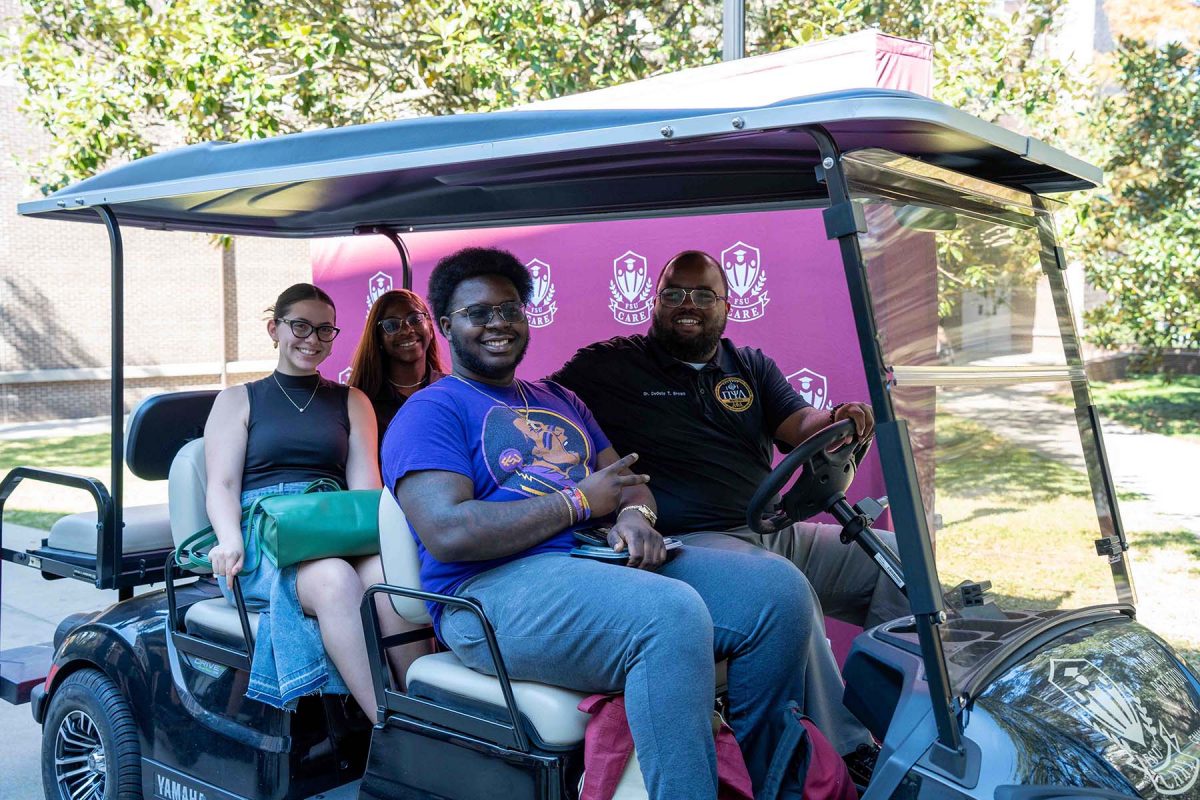 DeOnte Brown, far right, director of the Center for Academic Retention and Enhancement, drives other staff and CARE ambassadors in a golf cart during the annual National First-Generation College Celebration hosted at FSU. (Brittany Mobley, Undergraduate Studies)
