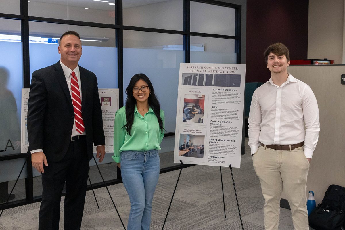 From left, FSU's Chief Information Officer Jonathan Fozard with two interns showcasing their work at the 2022 ITS annual open house. (FSU Information Technology Services)