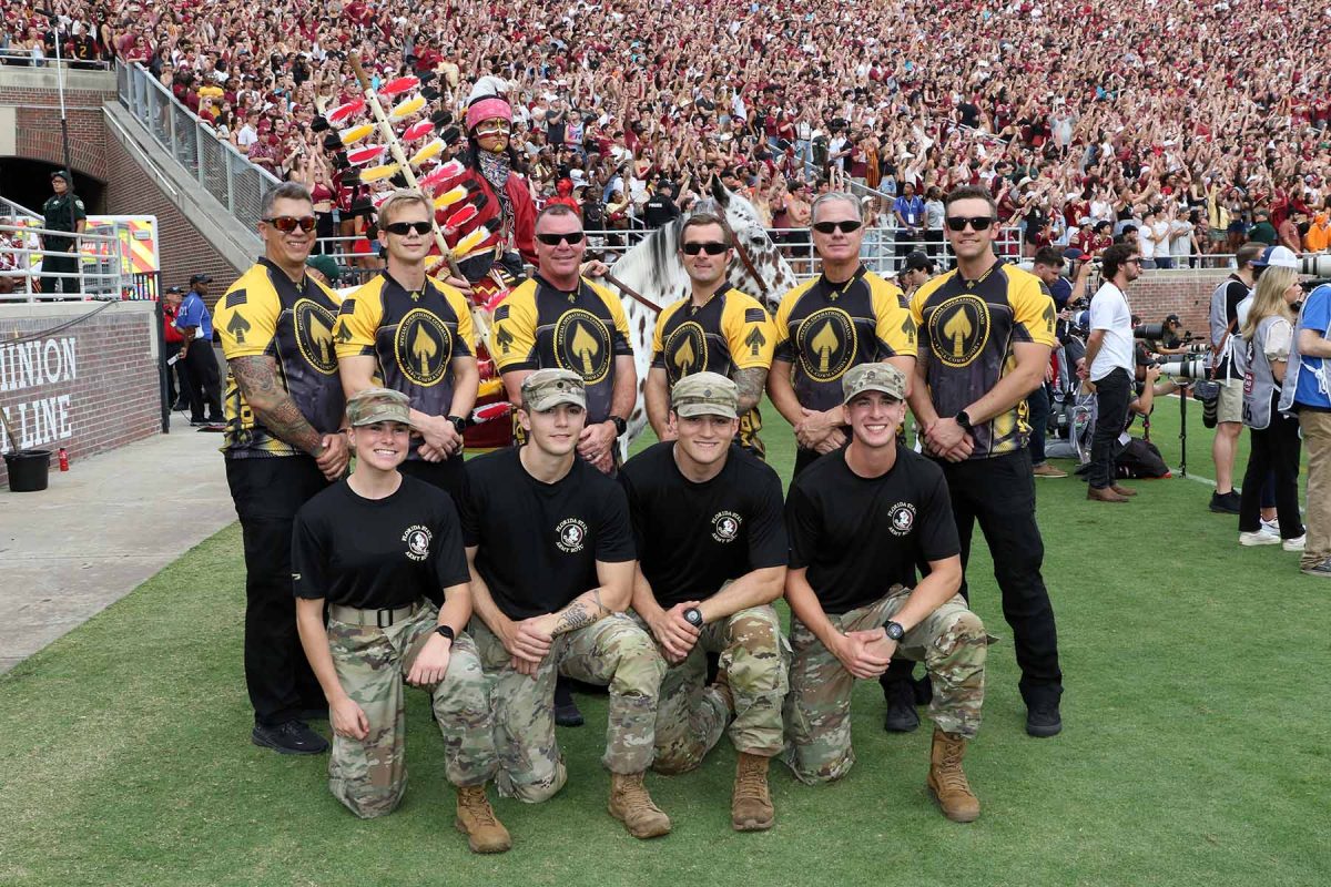 The paratrooper team from MacDill Air Force Base in Tampa pose with four of FSU's Army ROTC students at the Military Appreciation Game on Nov. 11, 2023. (Ryals Lee, FSU Athletics Photography)