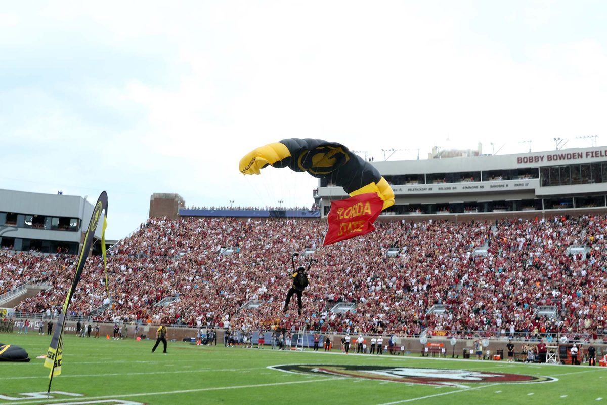 One of three paratroopers from MacDill Air Force Base in Tampa lands on the field with a Florida State flag at Doak S. Campbell Stadium on Nov. 11, 2023. (Ryals Lee, FSU Athletics Photography)