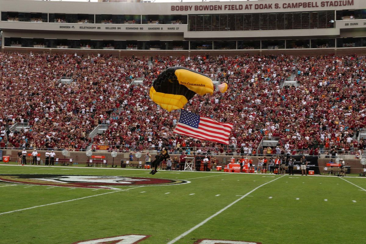 One of three paratroopers from MacDill Air Force Base in Tampa lands on the field with an American flag at Doak S. Campbell Stadium on Nov. 11, 2023. (Ryals Lee, FSU Athletics Photography)