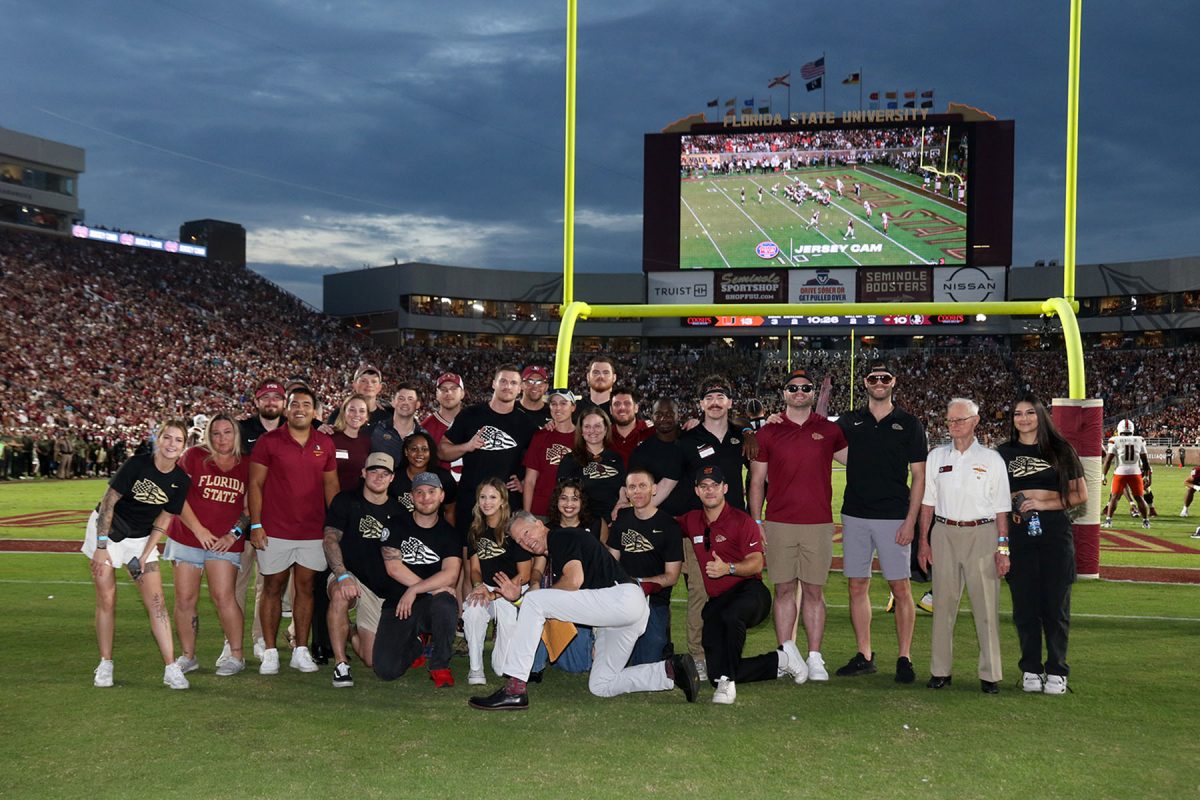 Director of the Student Veterans Center Billy Francis poses with veterans at the Military Appreciation Game on Nov. 11, 2023. (Ryals Lee, FSU Athletics Photography)