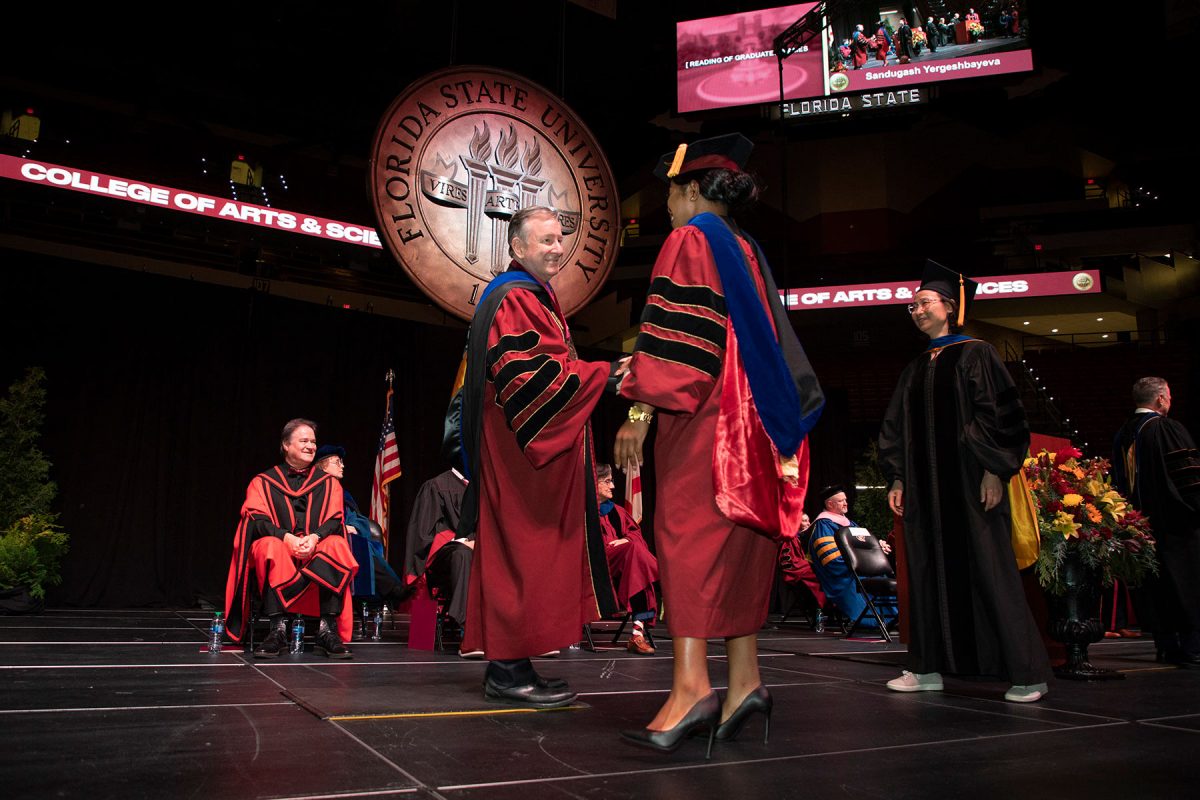 Florida State University President Richard McCullough congratulates a graduate during fall commencement Friday, Dec. 15, 2023, at the Donald L. Tucker Civic Center. (FSU Photography Services)