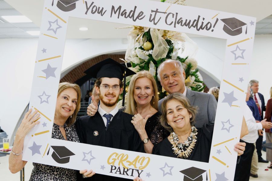 Graduate Claudio Del Balzo takes a picture with his family after FSU-Panama's 2023 commencement ceremony Tuesday, Dec. 5, at the City of Knowledge Convention Center in Panama City, Panama. (FSU-Panama, Pedro Ahues)