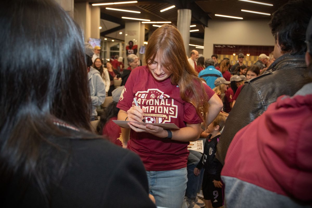 Florida State Women's Soccer team player Olivia Garcia signs autographs at the championship ceremony, Dec. 5, 2023. (FSU Photography)