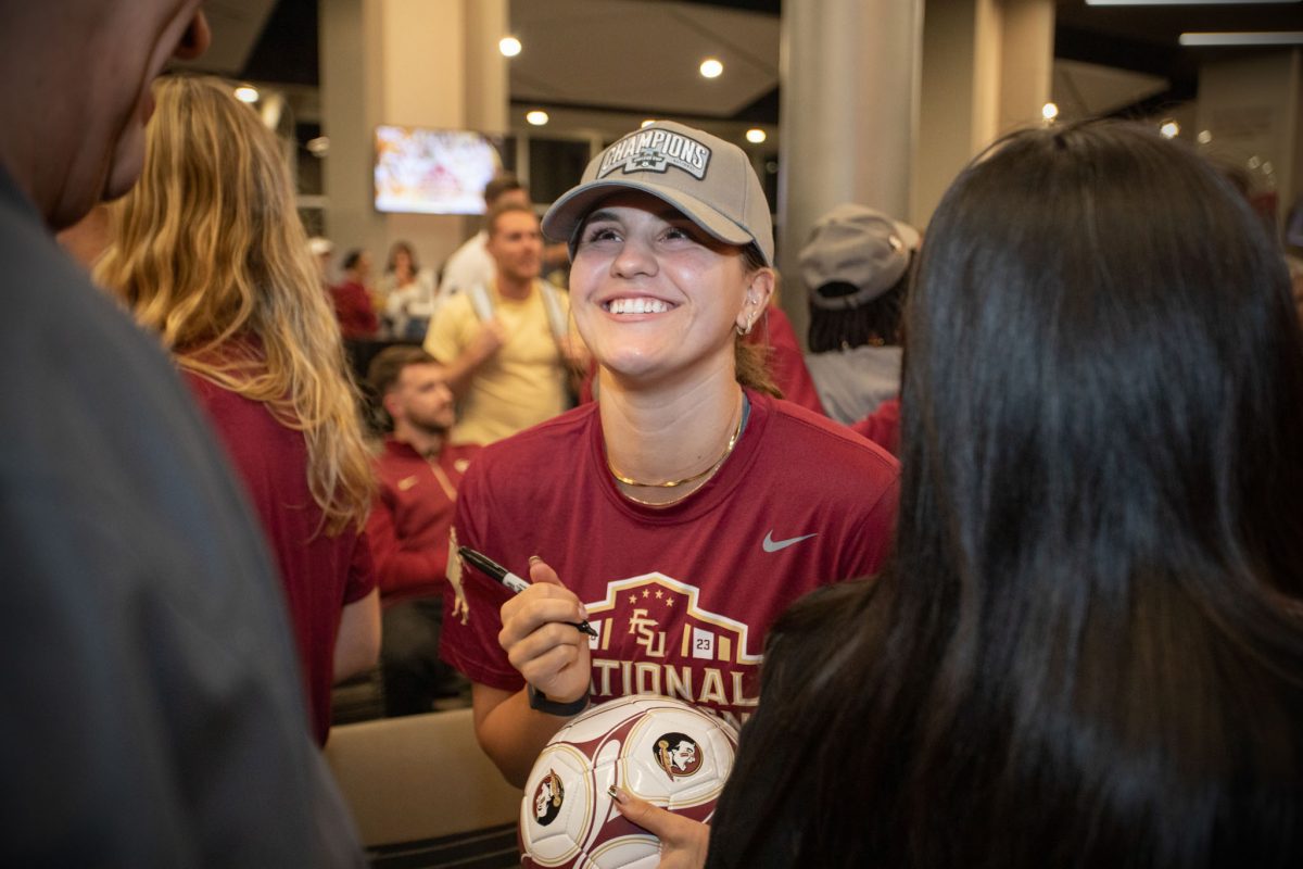 signs autographs at the championship ceremony held at the Champions Club, Dec. 5, 2023. (FSU Photography)