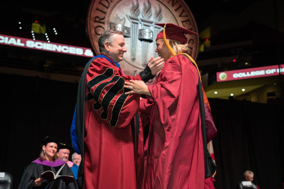 Florida State University President Richard McCullough congratulates a graduate during the fall commencement ceremony Friday, Dec. 15, 2023, at the Donald L. Tucker Civic Center. (FSU Photography Services)