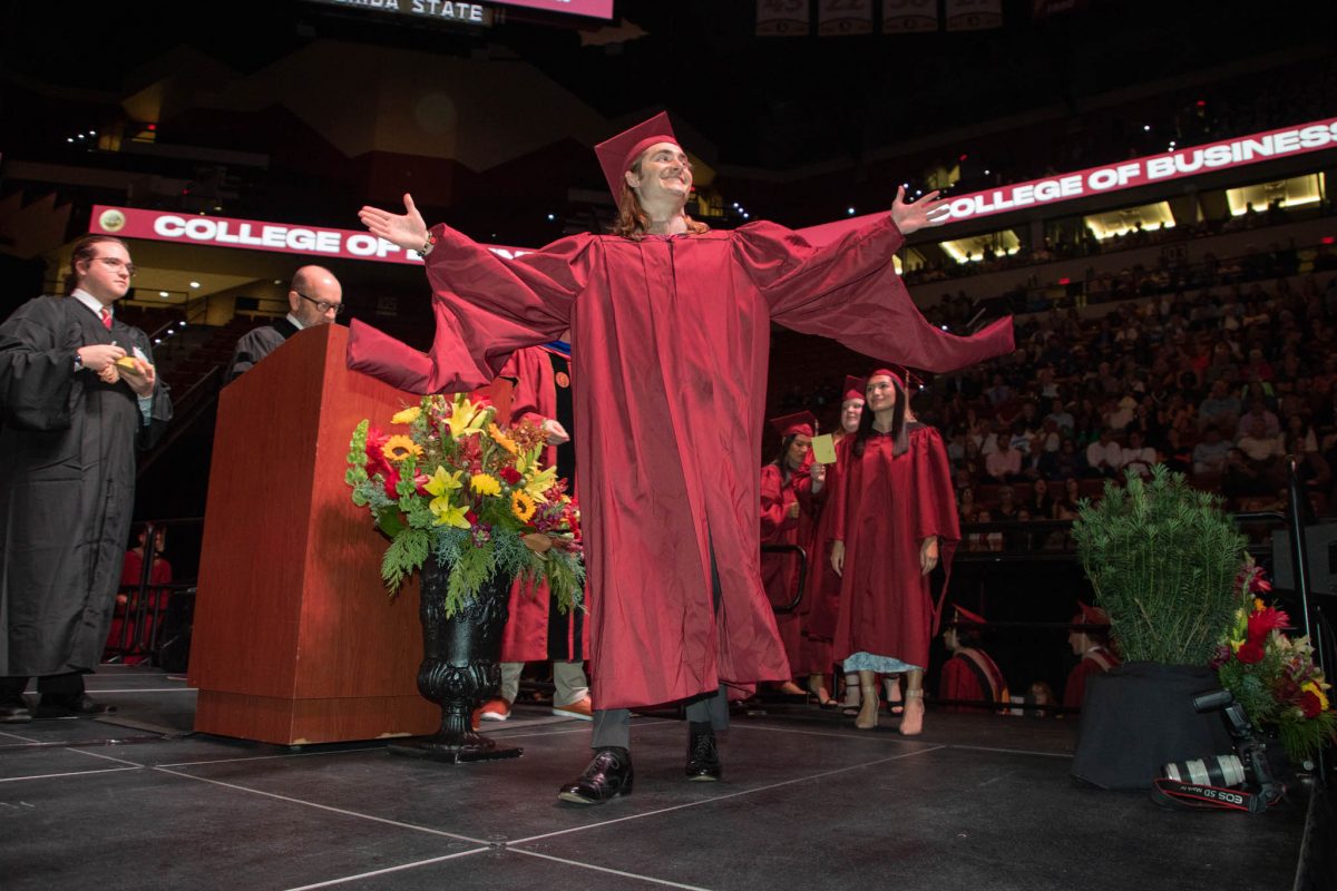 A Florida State University graduate celebrates during fall commencement Friday, Dec. 15, 2023, at the Donald L. Tucker Civic Center. (FSU Photography Services)
