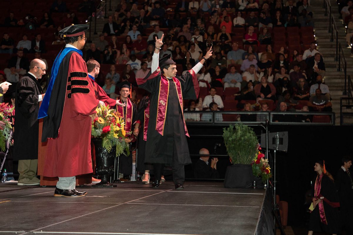 A student celebrates during commencement Friday, Dec. 15, 2023, at the Donald L. Tucker Civic Center. (FSU Photography Services)