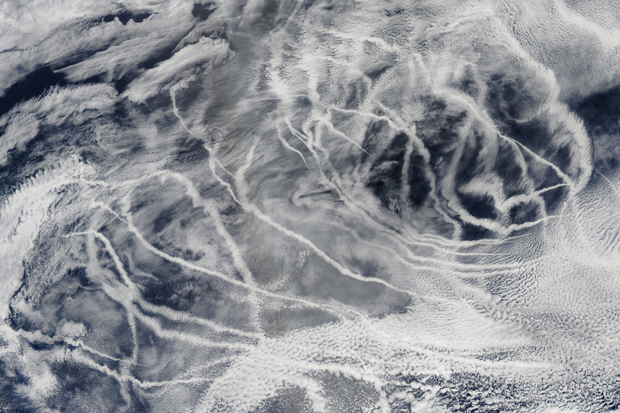 'Ship tracks' above the northern Pacific Ocean show up as long lines on this image taken by the Moderate Resolution Imaging Spectroradiometer onboard NASA’s Aqua satellite in 2010. These patterns are produced when fine particles from ship exhaust float into a moist layer of atmosphere. The particles seed new clouds or attract water from existing cloud particles. (Image by: NASA/GSFC/Jeff Schmaltz/MODIS Land Rapid Response Team)