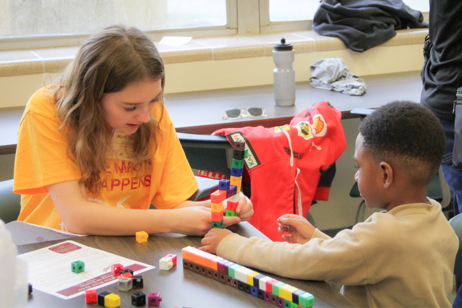 An FSU student helps a Math Fun Day attendee. (Meredith Breen/College of Arts and Sciences)