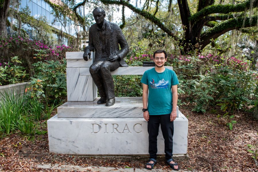 International student Aashutosh Pokharel in front of the Paul A.M. Dirac statue. Dirac served on the Florida State physics faculty from 1972 until his death in 1984. His legacy lives on as students and faculty work in the Dirac Science Library and pass by his statue on campus. (FSU Center for Global Engagement)