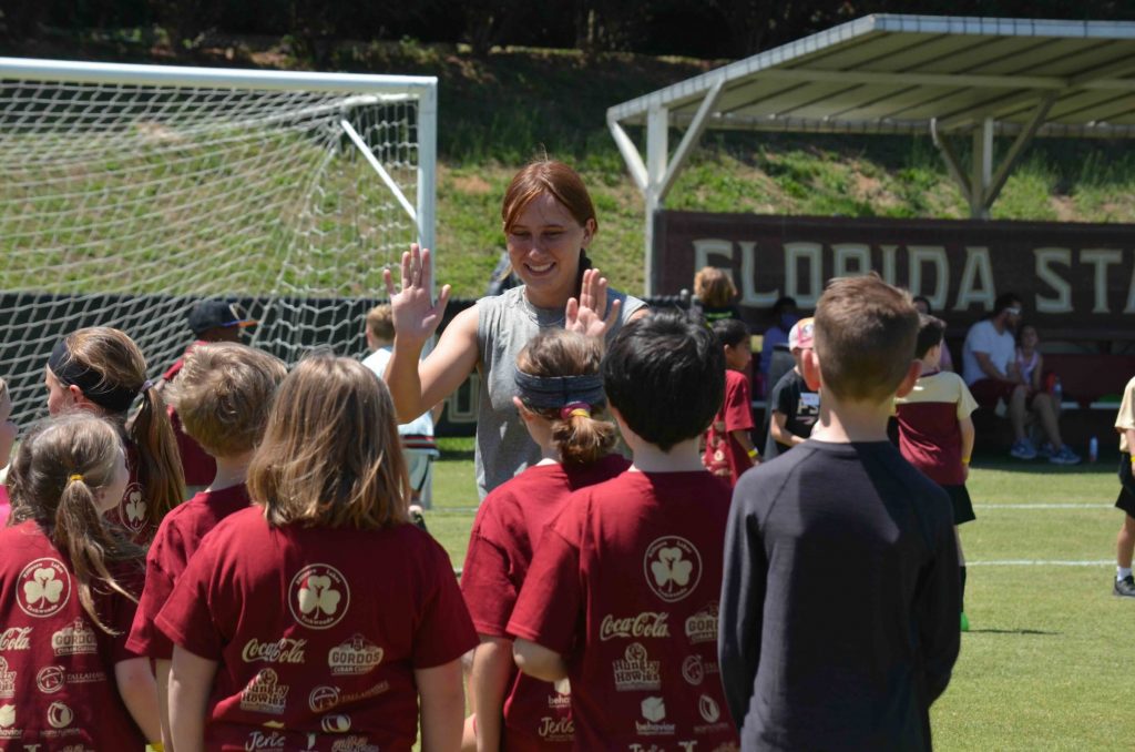 Photo credit: Former FSU soccer player Olivia Garcia leads participants through a cheer during the 2023 Kickin’ It For Autism Event. (Cathy Zenko)