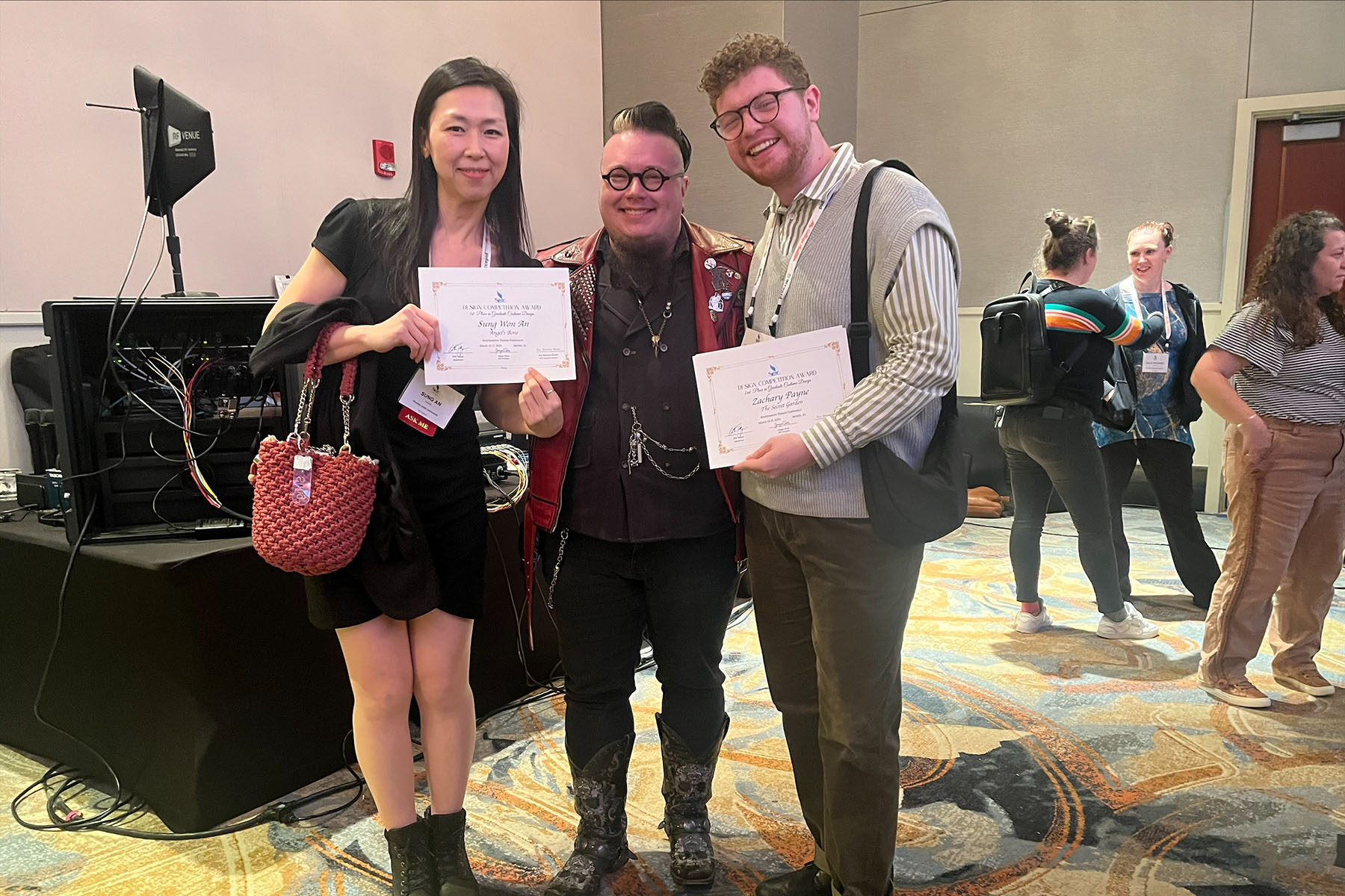 Sungwon An (left) and Zachary Payne (right) pose with costume designer Erik Reagan Teague, who served at the convention’s keynote speaker and judged the design competition.