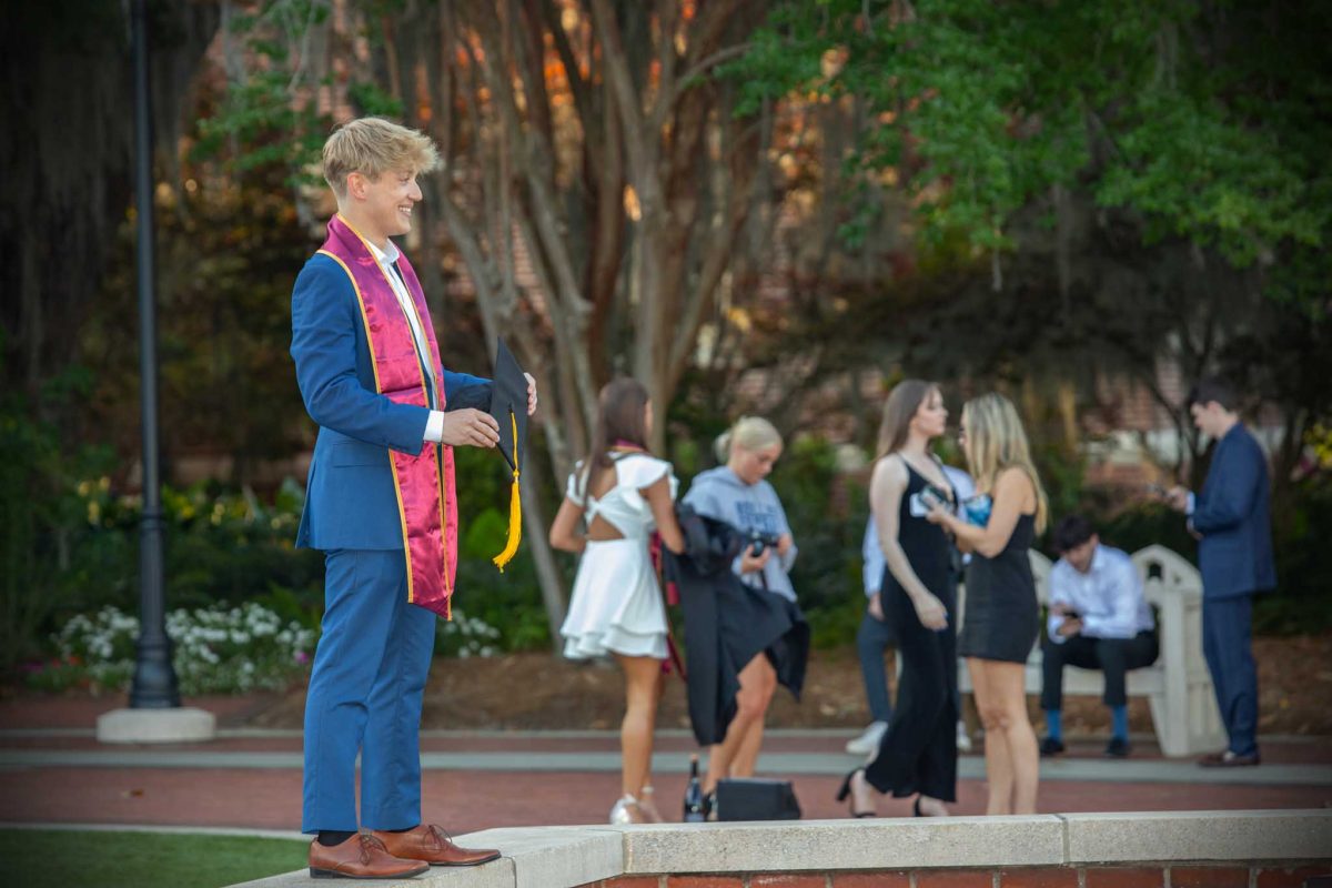 A graduate poses for photos in front of the Westcott Fountain on May 1, 2024. (FSU Photography)