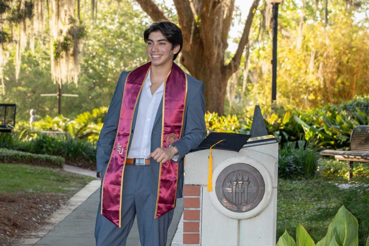A graduate poses for photos at Westcott Plaza on May 1, 2024. (FSU Photography)