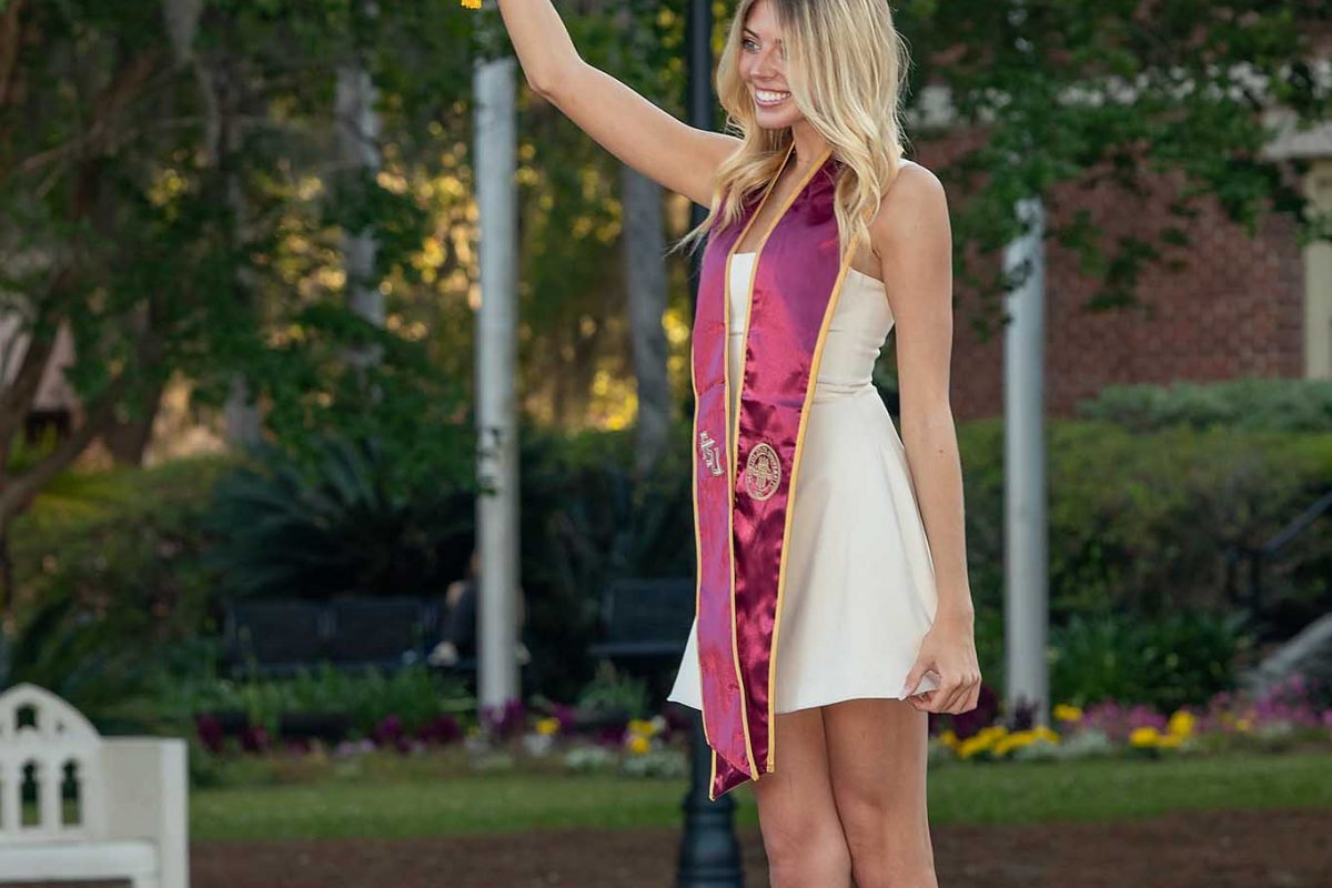 A graduate poses for photos in front of Westcott Fountain on May 1, 2024. (FSU Photography)