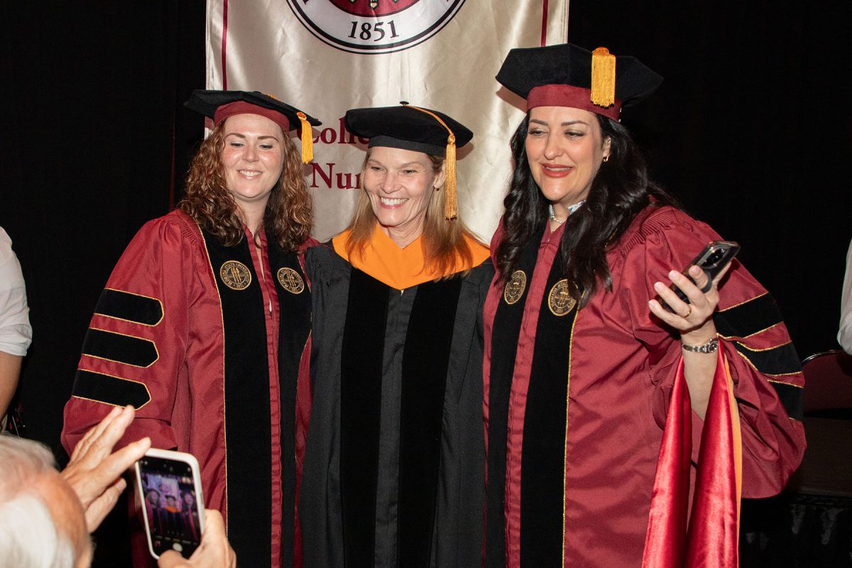Graduates and a faculty member pose for a photo at the spring doctoral hooding ceremony Friday, May 3, 2024, at the Donald L. Tucker Civic Center. (FSU Photography)