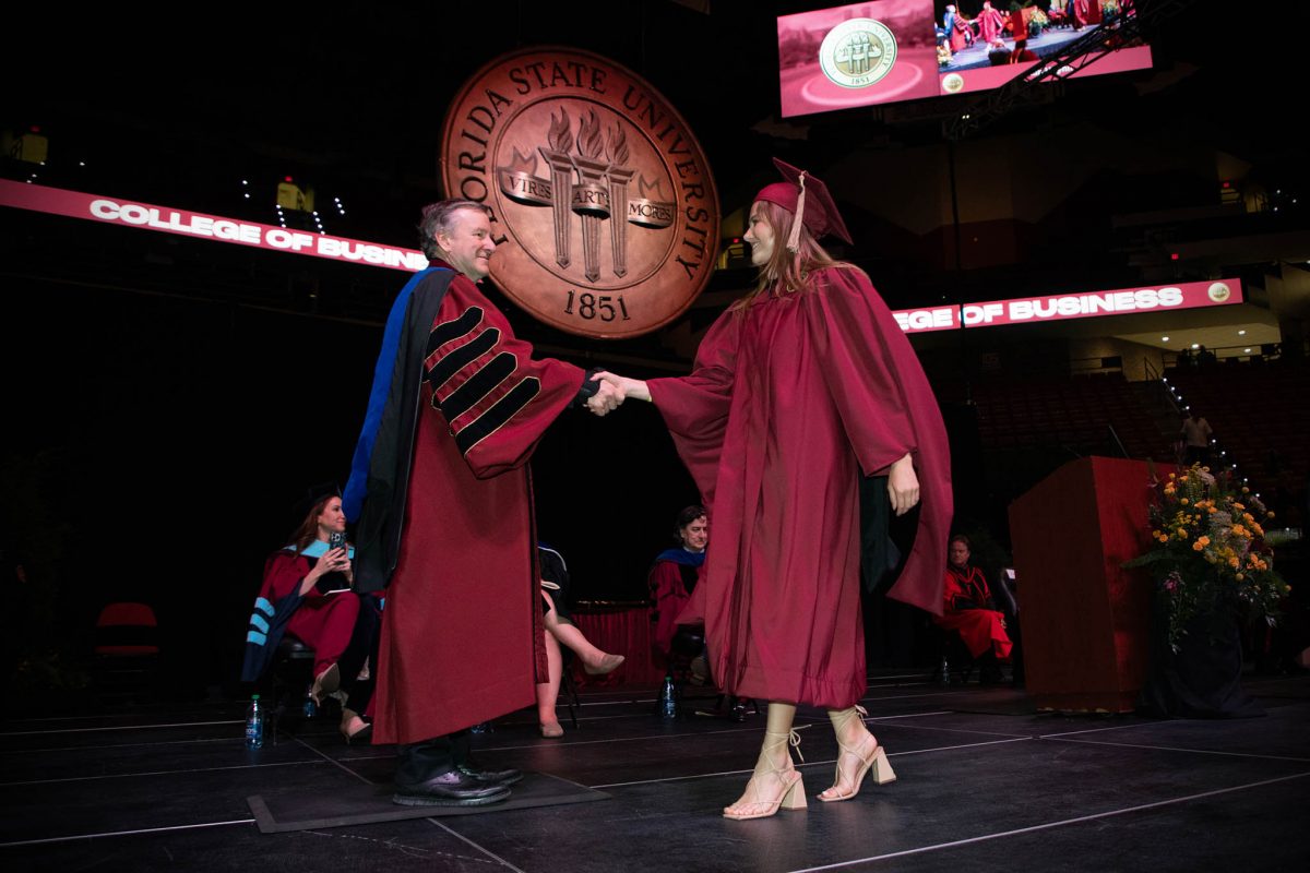President Richard McCullough congratulates a graduate during one of FSU's spring 2024 commencement ceremonies Friday, May 3, at the Donald L. Tucker Civic Center. (FSU Photography Services)