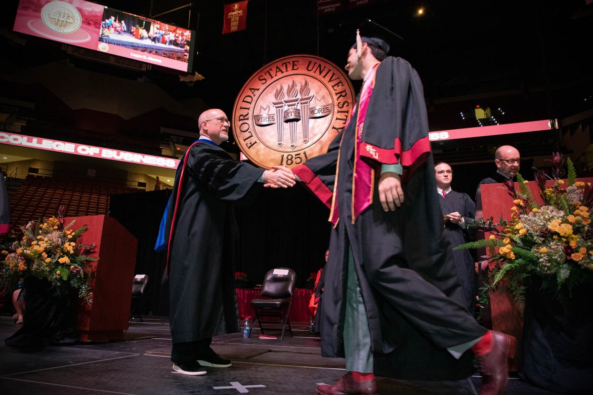 A Florida State University graduate crosses the stage during one of FSU's spring 2024 commencement ceremonies Friday, May 3, at the Donald L. Tucker Civic Center. (FSU Photography)
