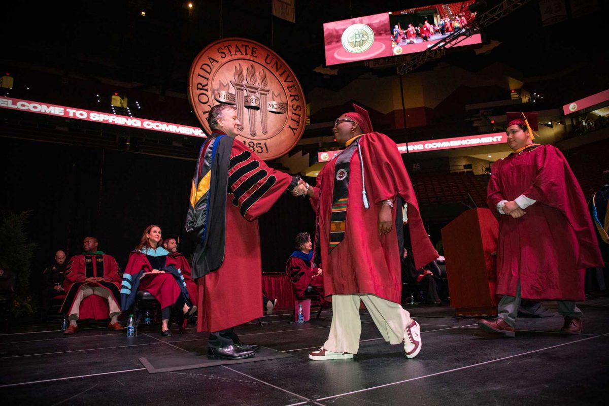 FSU President Richard McCullough congratulates a graduate during one of FSU's spring 2024 commencement ceremonies Saturday, May 4, 2024, at the Donald L. Tucker Civic Center. (FSU Photography Services)
