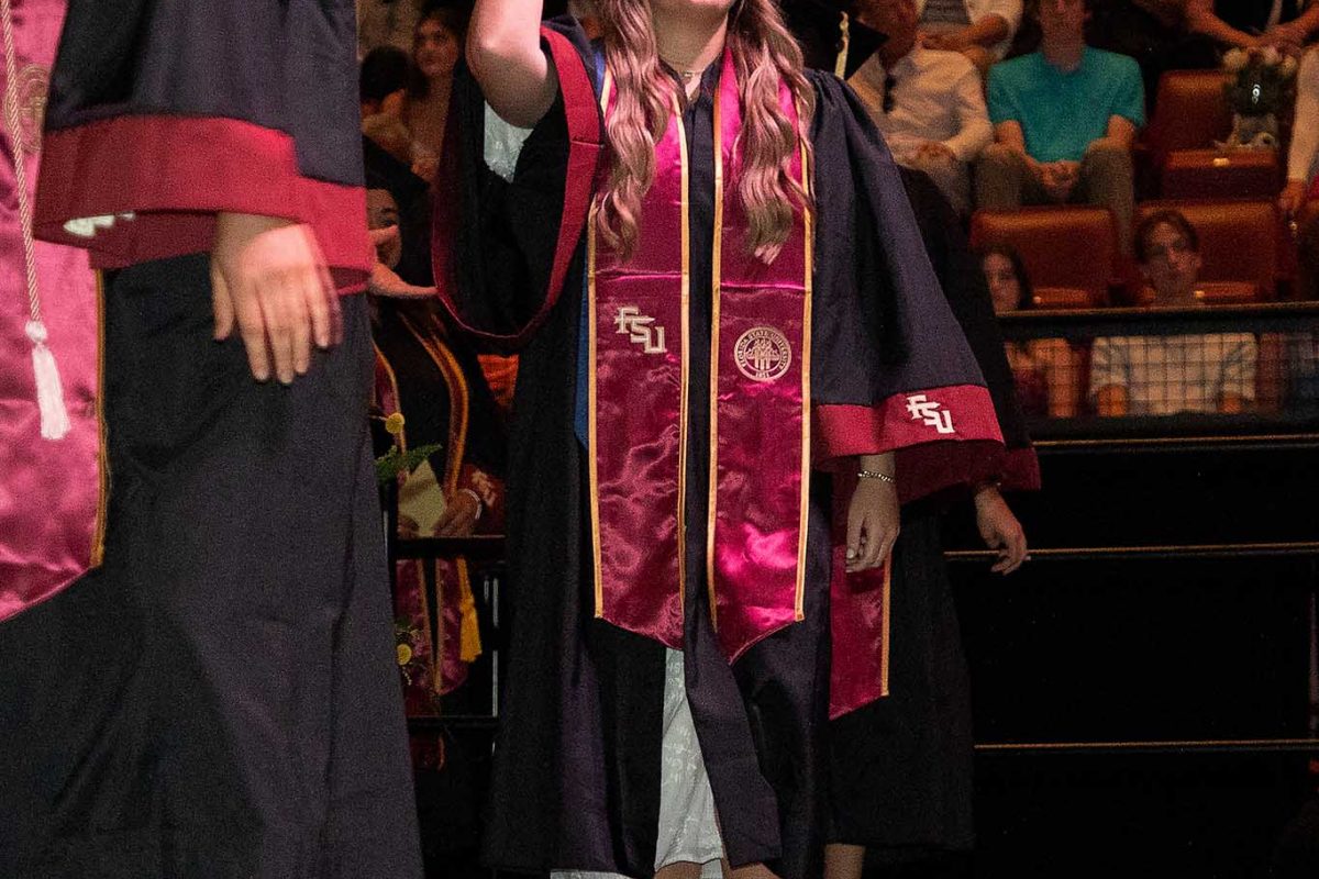 A Florida State University graduate celebrates during one of FSU's spring 2024 commencement ceremonies Friday, May 3, 2024, at the Donald L. Tucker Civic Center. (FSU Photography Services)