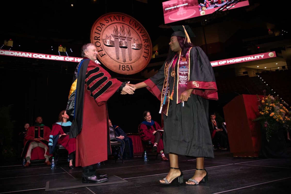 FSU President Richard McCullough congratulates a graduate during one of FSU's spring 2024 commencement ceremonies Saturday, May 4, 2024, at the Donald L. Tucker Civic Center. (FSU Photography Services)