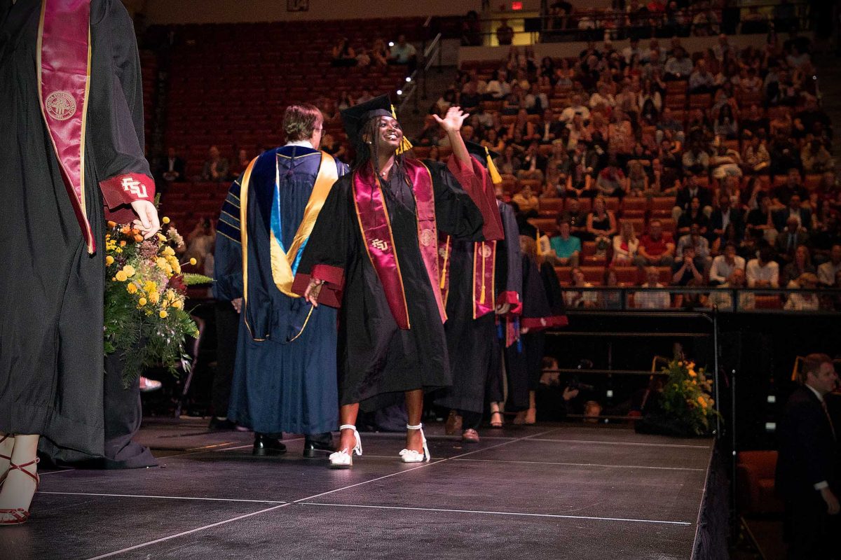 A Florida State University graduate celebrates during one of FSU's spring 2024 commencement ceremonies Saturday, May 4, 2024, at the Donald L. Tucker Civic Center. (FSU Photography Services)