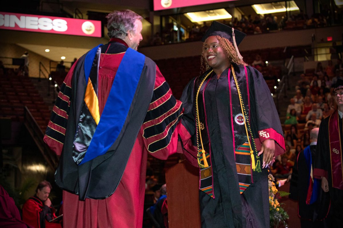 FSU President Richard McCullough shakes hands with a graduate during one of FSU's 2024 commencement ceremonies. (FSU Photography Services)