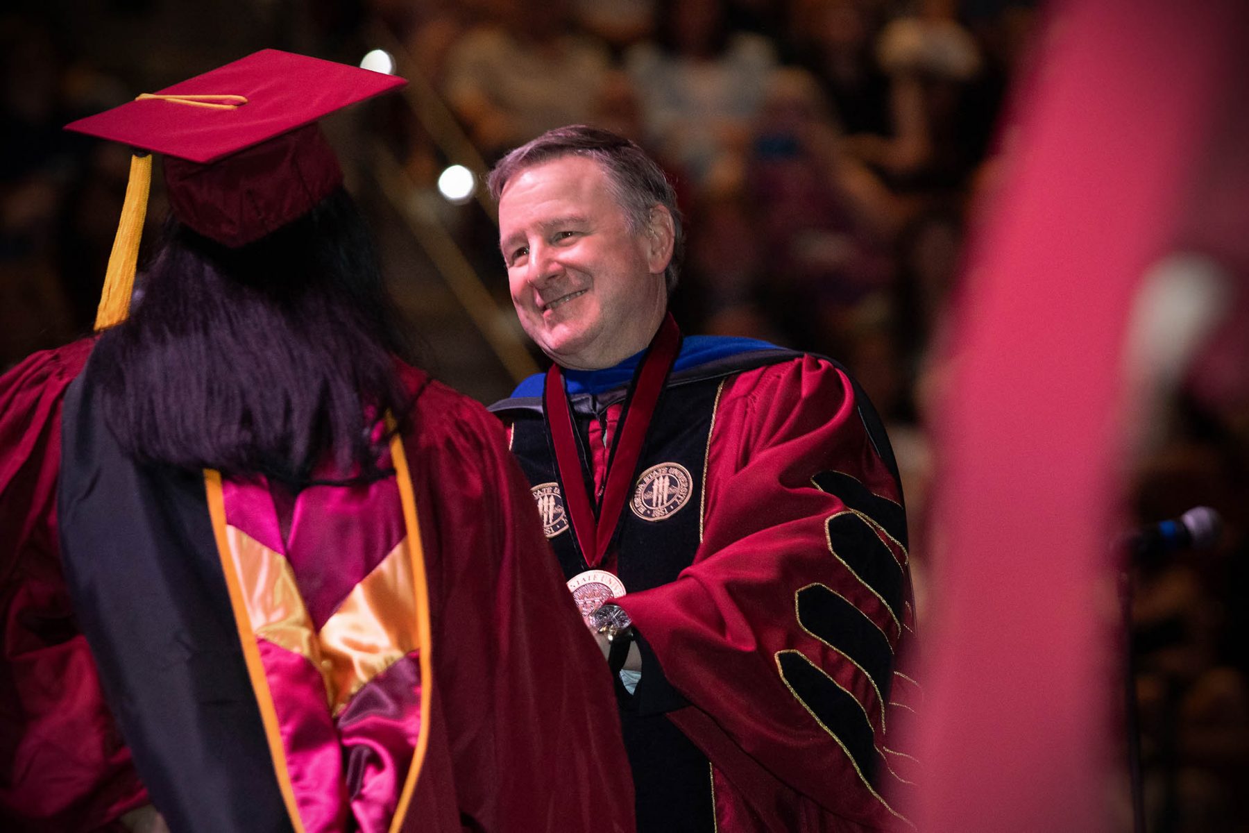 President Richard McCullough congratulates a graduate during FSU's commencement ceremony at 7 p.m. Friday, May 3, 2024, at the Donald L. Tucker Civic Center. (FSU Photography Services)