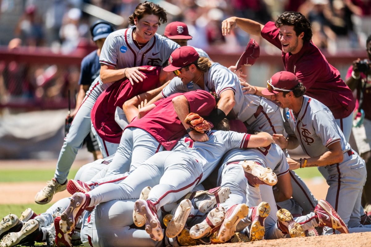 The Florida State Seminoles celebrate after defeating the UConn Huskies, 10-8, in extra innings to win the Tallahassee Super Regional and secure their bid to the College World Series on June 8, 2024. (Photo by Matthew McConnell/Florida State University)