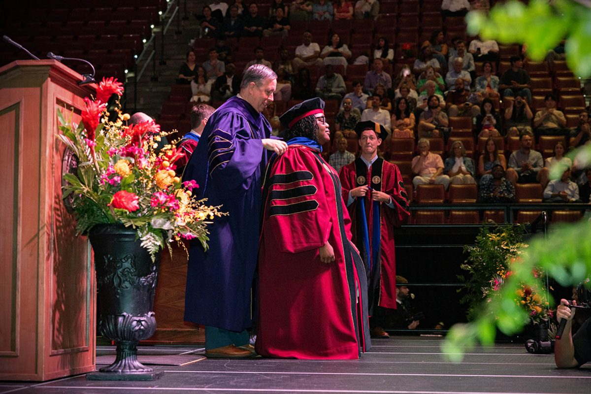 A Florida State University faculty member hoods a doctoral graduate at the summer doctoral hooding ceremony Friday, Aug. 2, 2024, at the Donald L. Tucker Civic Center. (FSU Photography)