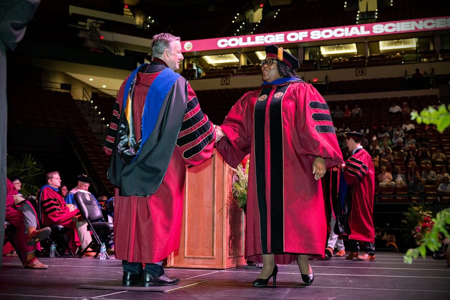 Florida State University President Richard McCullough congratulates a graduate at the summer doctoral hooding ceremony Friday, Aug. 2, 2024, at the Donald L. Tucker Civic Center. (FSU Photography)