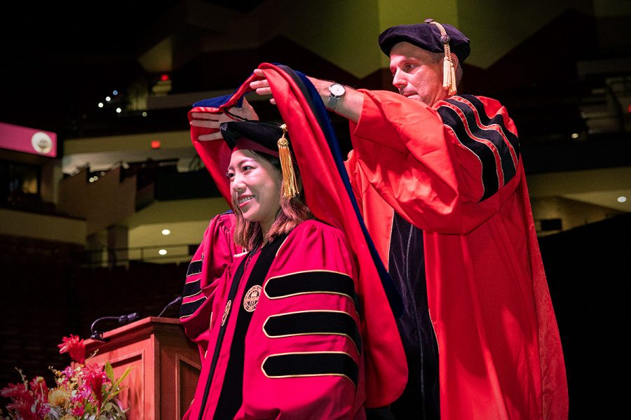 A Florida State University faculty member hoods a doctoral graduate at the summer doctoral hooding ceremony Friday, Aug. 2, 2024, at the Donald L. Tucker Civic Center. (FSU Photography)