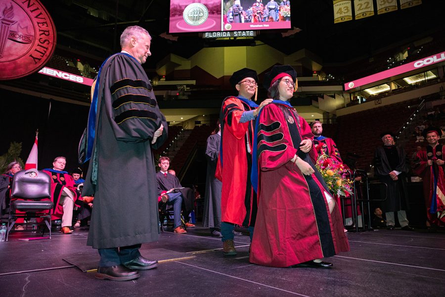 A Florida State University faculty member hoods a doctoral graduate at the summer doctoral hooding ceremony Friday, Aug. 2, 2024, at the Donald L. Tucker Civic Center. (FSU Photography)