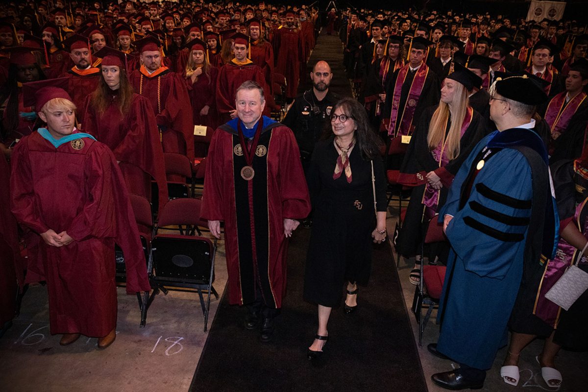 FSU President Richard McCullough and First Lady Jai Vartikar walk into FSU's summer 2024 commencement ceremony Friday, Aug. 2, 2024, at the Donald L. Tucker Civic Center. (FSU Photography)