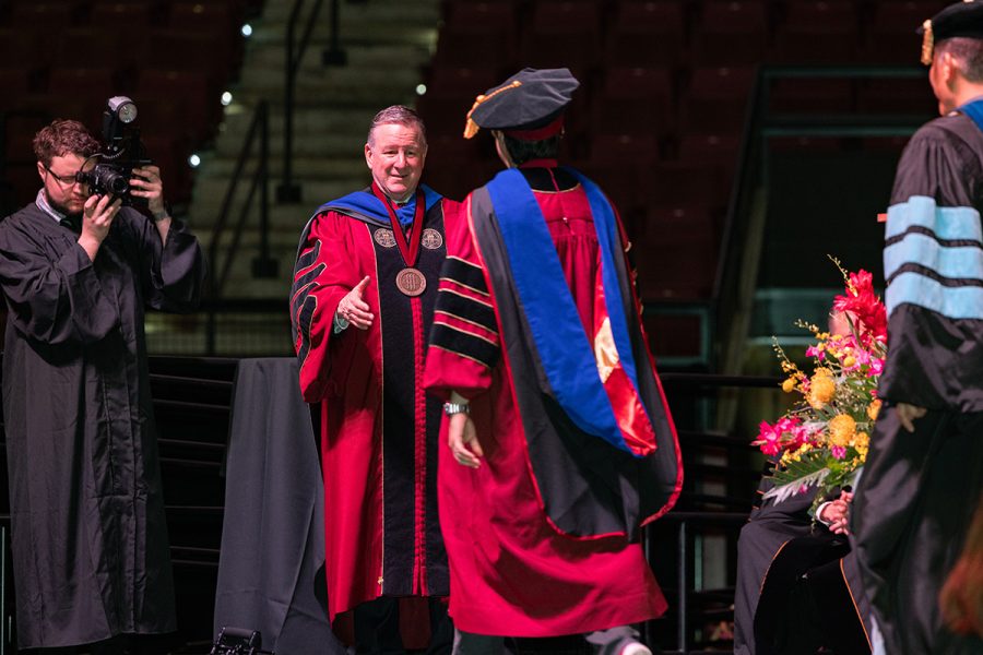 Florida State University President Richard McCullough congratulates a graduate at the summer doctoral hooding ceremony Friday, Aug. 2, 2024, at the Donald L. Tucker Civic Center. (FSU Photography)