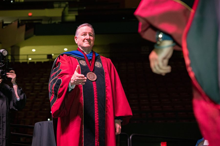 Florida State University President Richard McCullough congratulates a graduate at the summer doctoral hooding ceremony Friday, Aug. 2, 2024, at the Donald L. Tucker Civic Center. (FSU Photography)