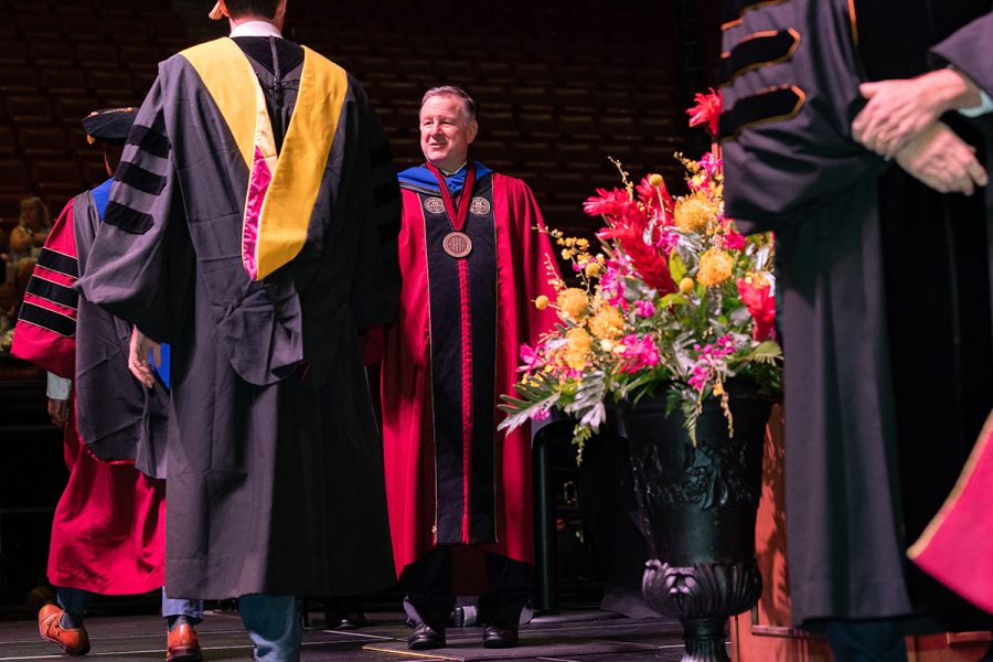 Florida State University President Richard McCullough congratulates a graduate at the summer doctoral hooding ceremony Friday, Aug. 2, 2024, at the Donald L. Tucker Civic Center. (FSU Photography)