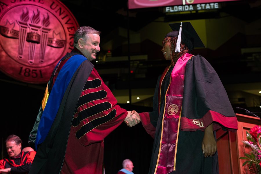 President Richard McCullough congratulates a graduate during one of FSU's summer commencement ceremonies Friday, Aug. 2, 2024, at the Donald L. Tucker Civic Center. (FSU Photography Services)