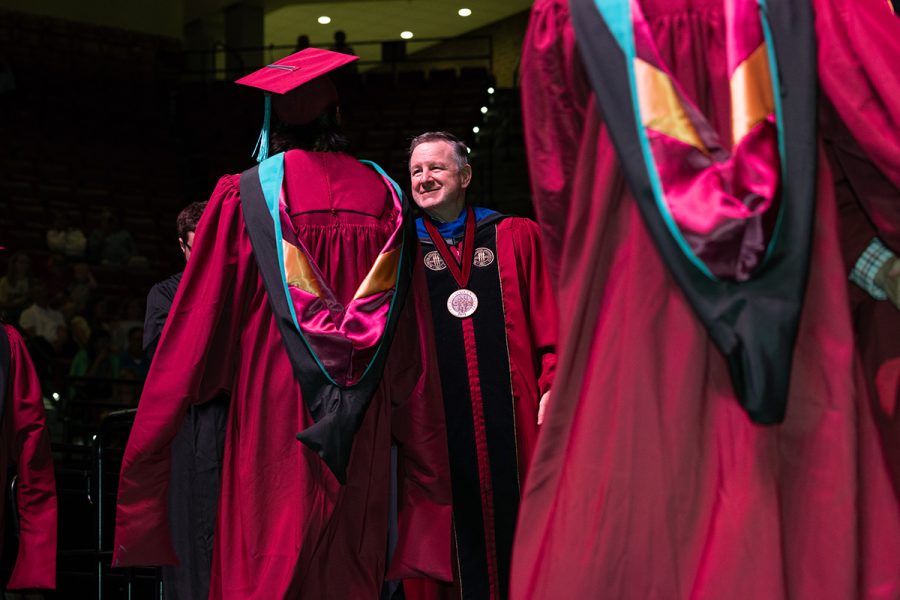 President Richard McCullough congratulates a graduate during one of FSU's summer commencement ceremonies Friday, Aug. 2, 2024, at the Donald L. Tucker Civic Center. (FSU Photography Services)