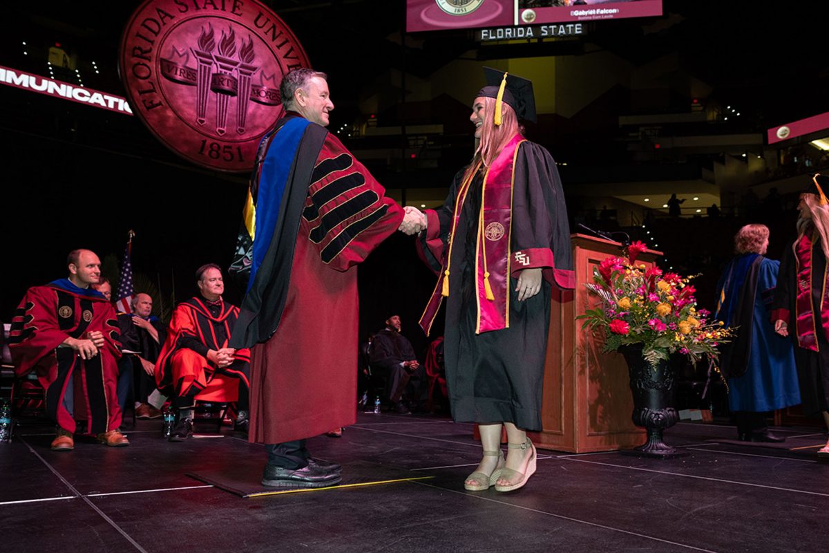 President Richard McCullough congratulates a graduate during one of FSU's summer commencement ceremonies Friday, Aug. 2, 2024, at the Donald L. Tucker Civic Center. (FSU Photography Services)